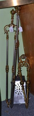 Lot 198 - A three piece brass and steel companion set and similar tongs (4)