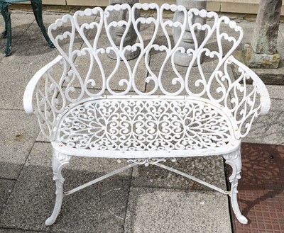 Lot 1115 - A pair of white painted cast metal benches...