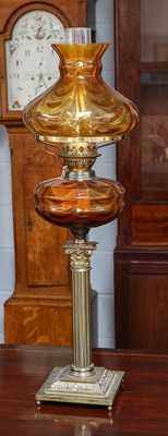 Lot 1230 - A Victorian oil lamp with amber glass...