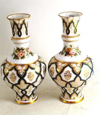 Lot 235 - A pair of Victorian floral painted white opaque glass vases