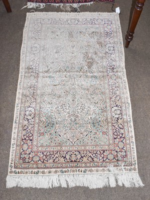 Lot 1237 - A Chinese silk prayer rug, the faded rose pink...