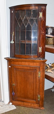 Lot 1292 - A Georgian oak hanging corner cupboard,...