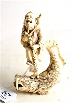 Lot 267 - A Japanese carved walrus ivory ronin on catfish (a.f.)