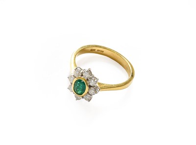 Lot 287 - An 18 carat gold emerald and diamond cluster...