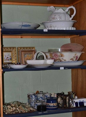 Lot 284 - Three shelves of ceramics and ornamental items including toilet ewers, an Imari charger, flower...