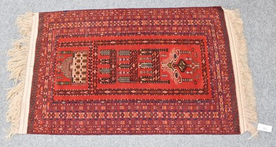 Lot 1096 - An Afghan Turkmen prayer rug, the brick red...