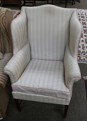 Lot 1320 - Two wing chairs together with a tekke rug (3)