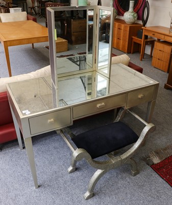 Lot 1152 - A silvered and mirrored dressing table, 122cm...