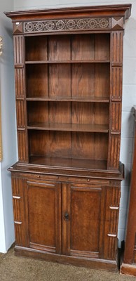 Lot 1185 - A pair of carved oak open bookcase cabinets,...