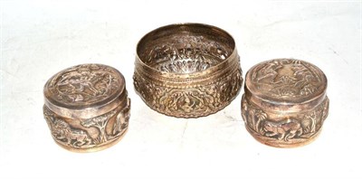 Lot 313 - A pair of Indian silver boxes and covers and a bowl, each repoussé with animals and figures