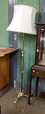 Lot 1373 - A brass standard lamp on scroll supports,...