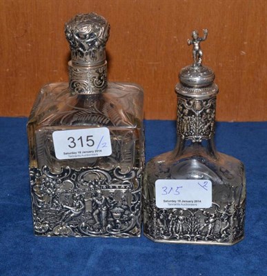 Lot 315 - A Dutch silver and engraved bottle with a smaller example