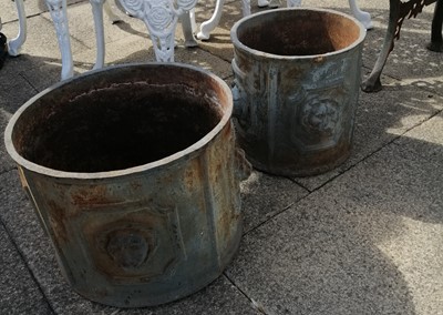 Lot 1113 - Two graduated iron planters decorated with...