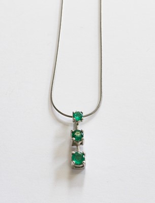 Lot 197 - An emerald drop pendant on a snake link chain,...