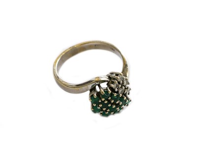 Lot 191 - An emerald and diamond cluster ring, stamped...