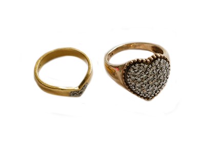 Lot 202 - A heart-shaped diamond cluster ring, stamped...