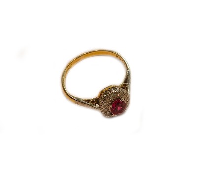 Lot 238 - An 18 carat gold ruby and diamond cluster ring,...