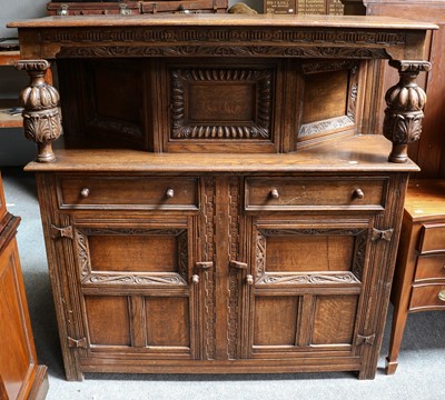 Lot 1213 - A 1920s carved oak court cupboard 137cm by...