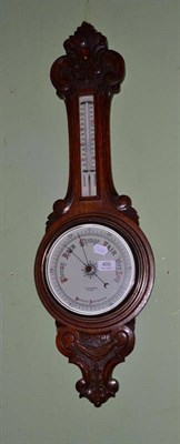 Lot 400 - An aneroid barometer/thermometer in an oak banjo case