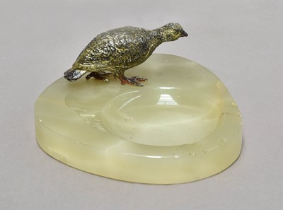 Lot 213 - An onyx and cold painted pin tray, surmounted...