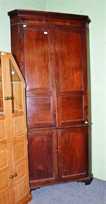 Lot 405 - A late George III mahogany straight-front floor standing corner cupboard