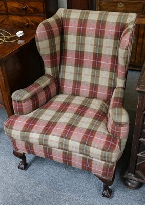 Lot 1241 - A wing back armchair in checkered fabric