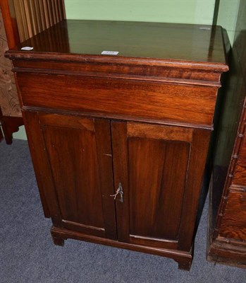 Lot 410 - A walnut sewing cabinet with hinged top