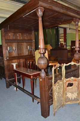 Lot 413 - An oak tester bed, the headboard set with a pair of candle sconces