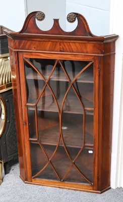 Lot 1175 - A mahogany hanging corner cupboard, with...