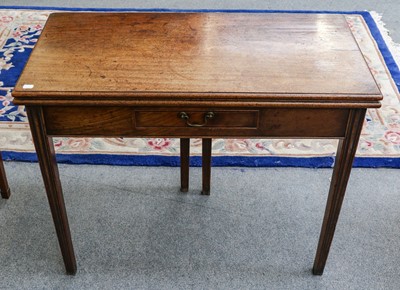 Lot 1144 - A George III mahogany foldover table with...