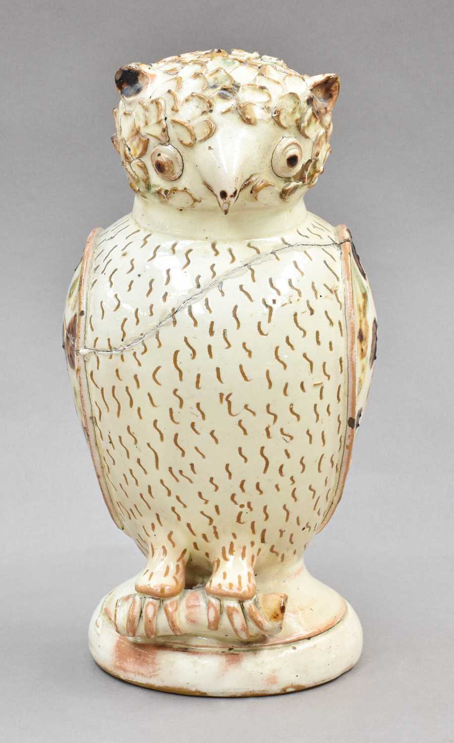 Lot 121 - A 19th century glazed earthenware owl form...