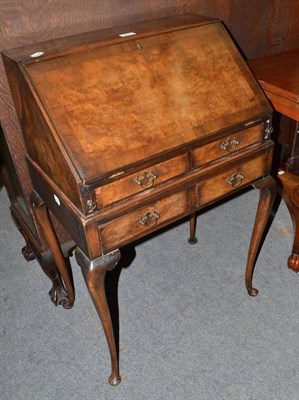 Lot 423 - A reproduction walnut bureau on stand