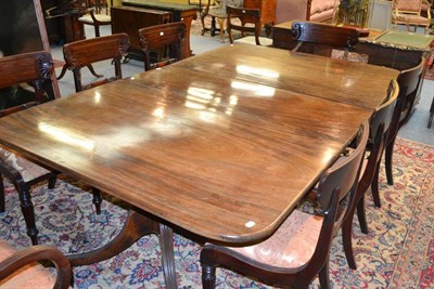 Lot 1219 - A Regency Mahogany Twin-Pillar Dining Table, circa 1820, of rounded rectangular form, raised on...