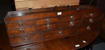 Lot 424 - Oak multi-drawer chest with recessed top (? ticket chest)