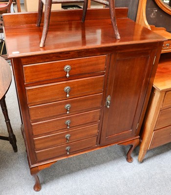 Lot 1144 - An early 20th century mahogany music cabinet...