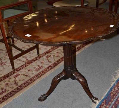 Lot 444 - Mahogany carved and scalloped-edge tripod table