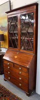 Lot 1098 - A George III inlaid mahogany bureau bookcase,...