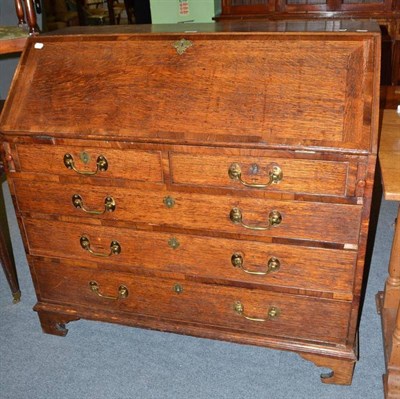 Lot 454 - A Georgian oak bureau