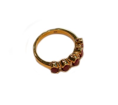 Lot 233 - An 18 carat gold ruby and diamond half hoop...