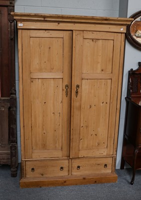 Lot 1130 - A pine double wardrobe, 123cm by 67cm by 188cm