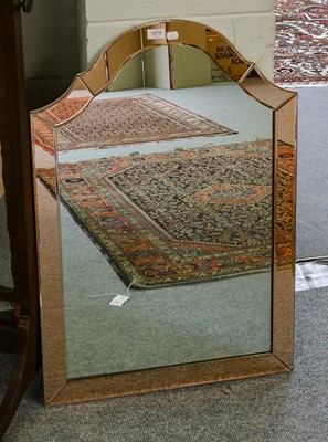 Lot 1079 - An Art Deco frameless wall mirror, the shaped...