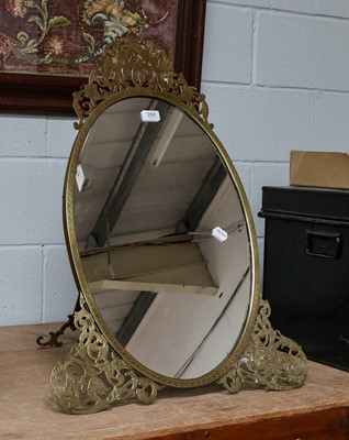 Lot 268 - A large oval strut mirror in engraved brass...