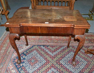 Lot 476 - Carved mahogany fold-over card table in the Irish George II style