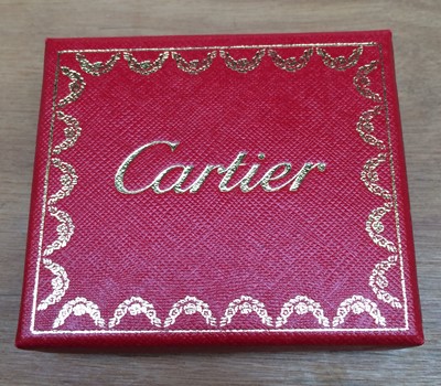 Lot 166 - Cartier: A pair of glasses; a silver pendant;...
