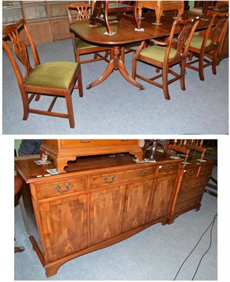 Lot 498 - A reproduction yew wood dining table, sideboard, a chest of drawers and a set of six...