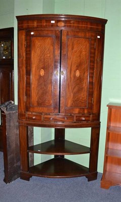 Lot 504 - A George III mahogany floor standing corner cupboard