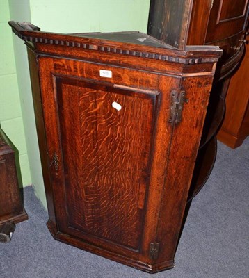 Lot 505 - A Georgian oak straight front hanging corner cupboard