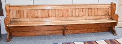 Lot 1258 - An early 20th century pitch pine pew 284cm