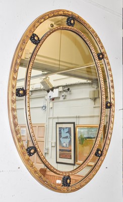 Lot 1253 - A gilt framed oval sectional wall mirror 76cm...