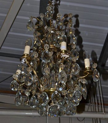 Lot 534 - A glass chandelier with facetted pear-shaped drops